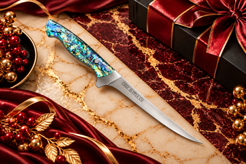 Chef Supply Co. fillet knife with an iridescent blue-green handle displayed on burgundy and cream marble with elegant gold accents and luxury gift packaging for New Year corporate gifting.