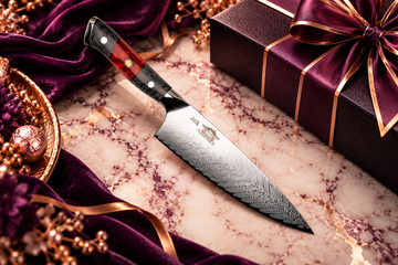 Chef Supply Co. Damascus chef knife with a black and red handle, displayed on cream marble with royal purple velvet, rose-gold accents, and elegant gift packaging for professional relationship gifting.