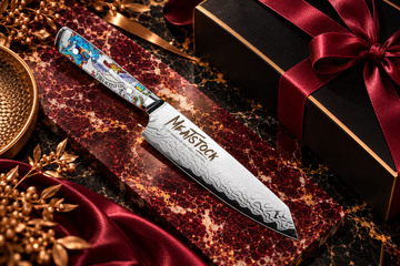 Chef Supply Co branded chef’s knife on burgundy marble with a black gift box and gold accents.