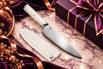 Chef Supply Co. chef knife with a white honeycomb handle and matching white leather sheath, styled on cream marble with royal amethyst velvet, rose-gold accents, and elegant gift packaging for corporate gift policy planning.
