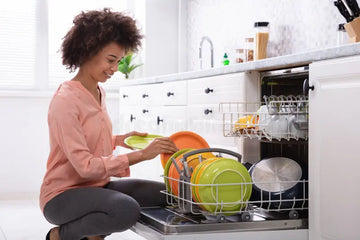Woman loading dishes into a dishwasher